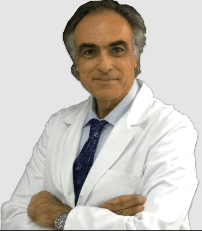 A professional wearing a white lab coat and blue tie, standing with arms crossed.